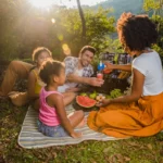Família feliz desfrutando de um dos muitos piqueniques ensolarados no campo.